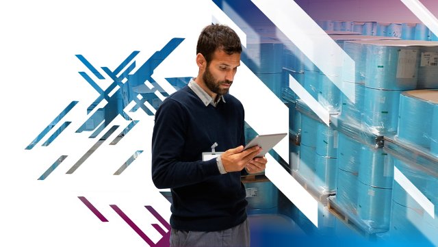 Man looking at ipad with stockpile in the background