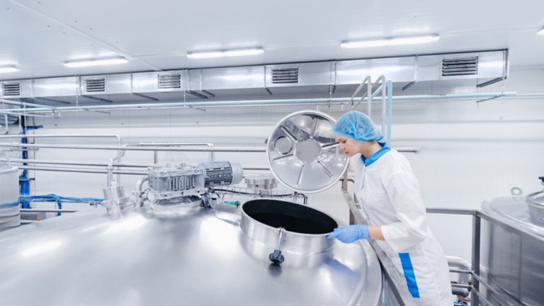 Worker looking into biroreactor